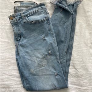 Light wash distressed hem jeans